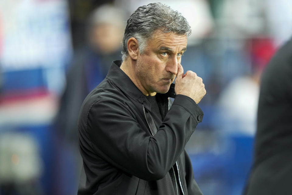 PSG's head coach Christophe Galtier enters to the field prior to the French League One soccer match between Paris Saint Germain and Lens at Parc des Princes stadium in Paris, France, Saturday, April 15, 2023. (AP Photo/Michel Euler)