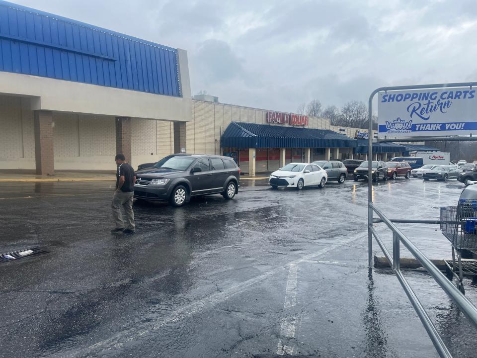 Cars line up outside of WoW Supermarket as Charlotte-based Carolina Complete Health hosted and sponsored a vaccination and food giveaway event in March 2022 at Dixie Village shopping center.