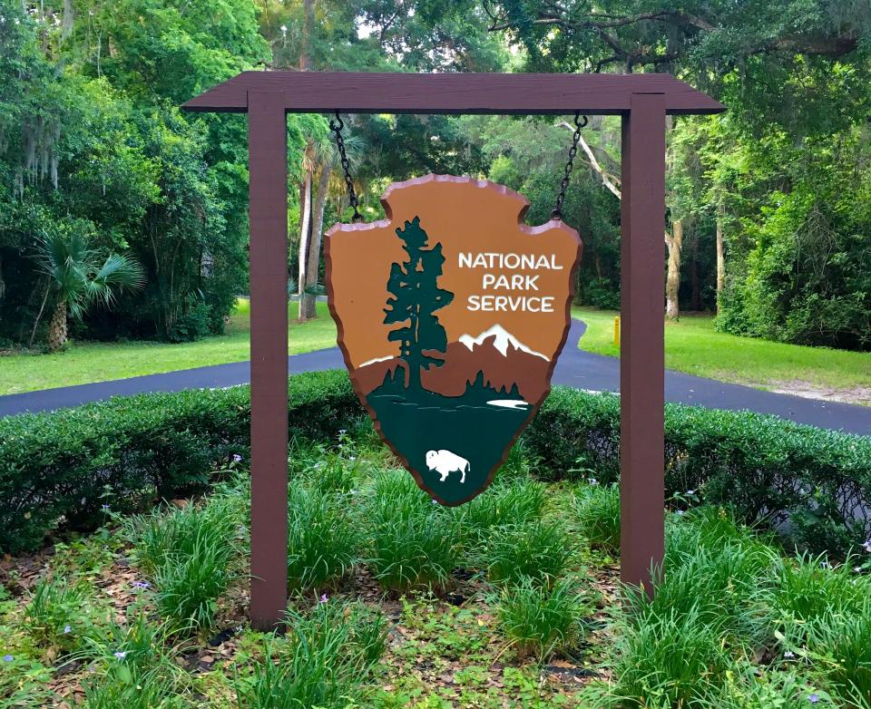 The National Park Service arrowhead sign at the entrance to Fort Caroline National Memorial.