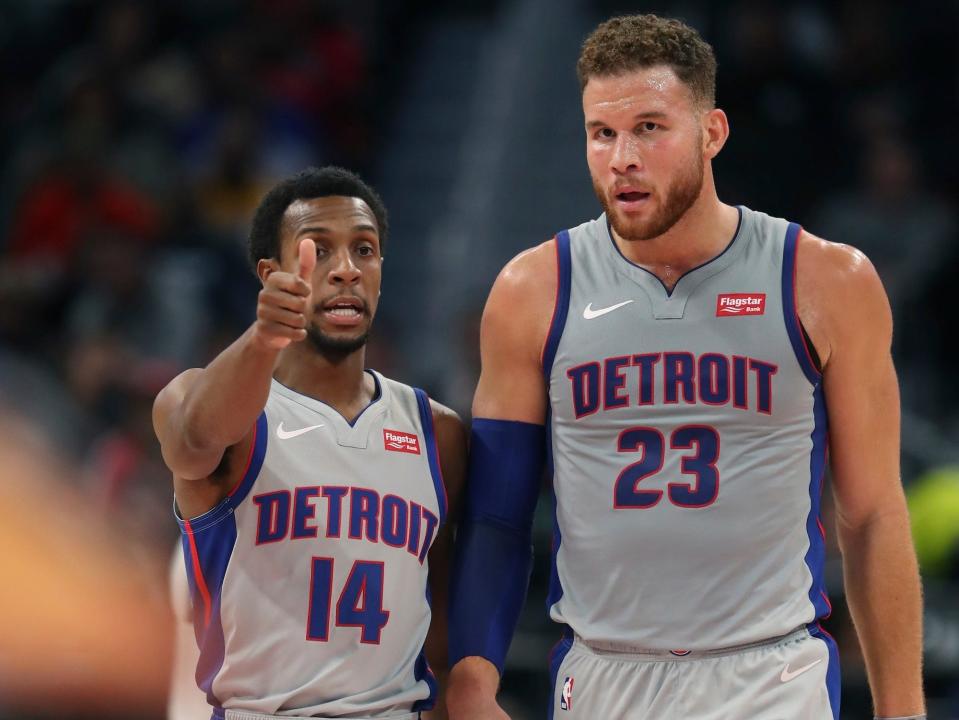 Ish Smith points while talking to Blake Griffin during a Pistons game in 2018.