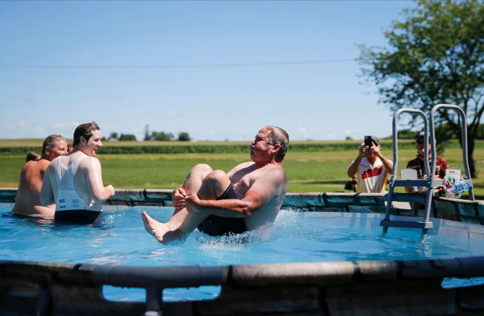 A cyclist splashes into a pool in Marble Rock during RAGBRAI on Thursday.