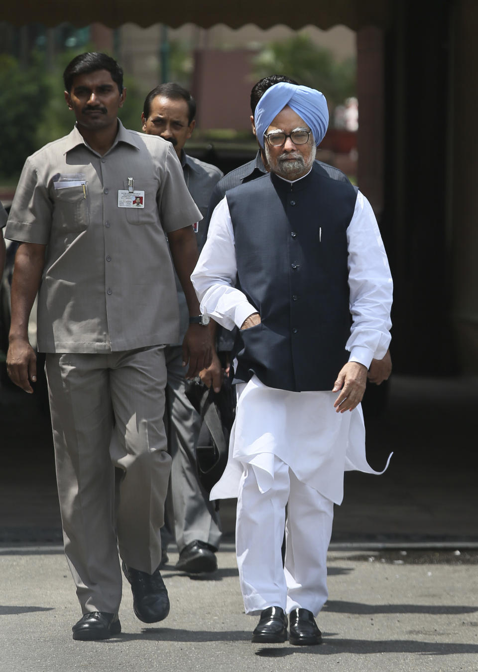 Indian Prime Minister Manmohan Singh, right, arrives to make a statement to the media after he was shouted down by opposition politicians in the lower house of Parliament, in New Delhi, India, Monday, Aug. 27, 2012. Singh took to Twitter on Monday to defend himself against a coal scandal roiling the country, saying accusations his government lost the country huge amounts of money were baseless. India's Parliament has been all but paralyzed since the national auditor released a report two weeks ago saying the sale of coal blocks without competitive bidding was expected to net private companies windfall profits of up to $34 billion. (AP Photo/Manish Swarup)