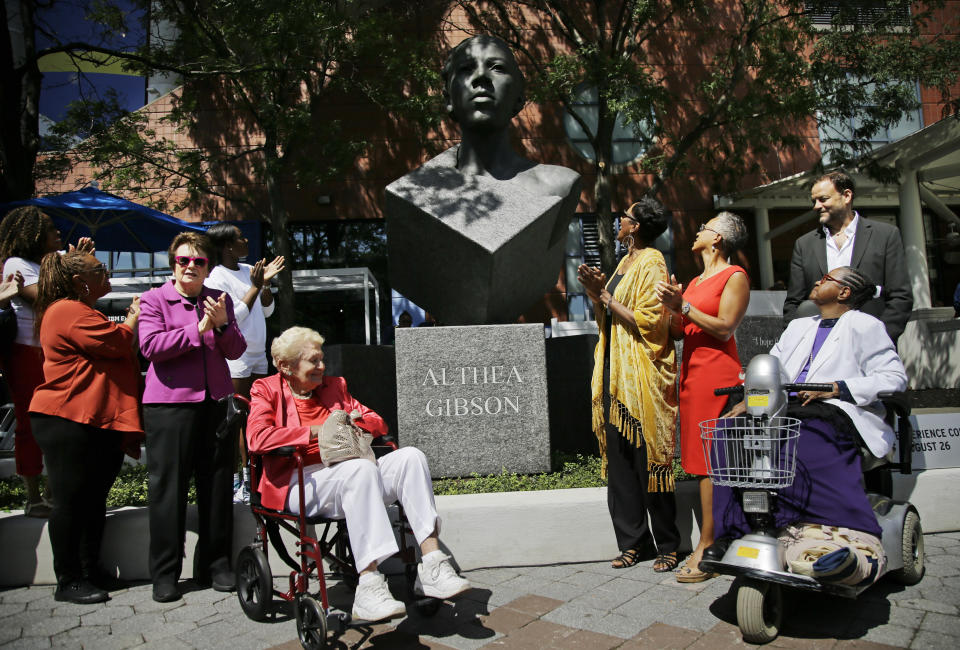 Billie Jean King, second from left, and Angela Buxton, third from left, applaud after the unveiling of a statue of Althea Gibson before the start of the first round of the US Open tennis championships, Monday, Aug. 26, 2019, in New York. (AP Photo/Frank Franklin II)