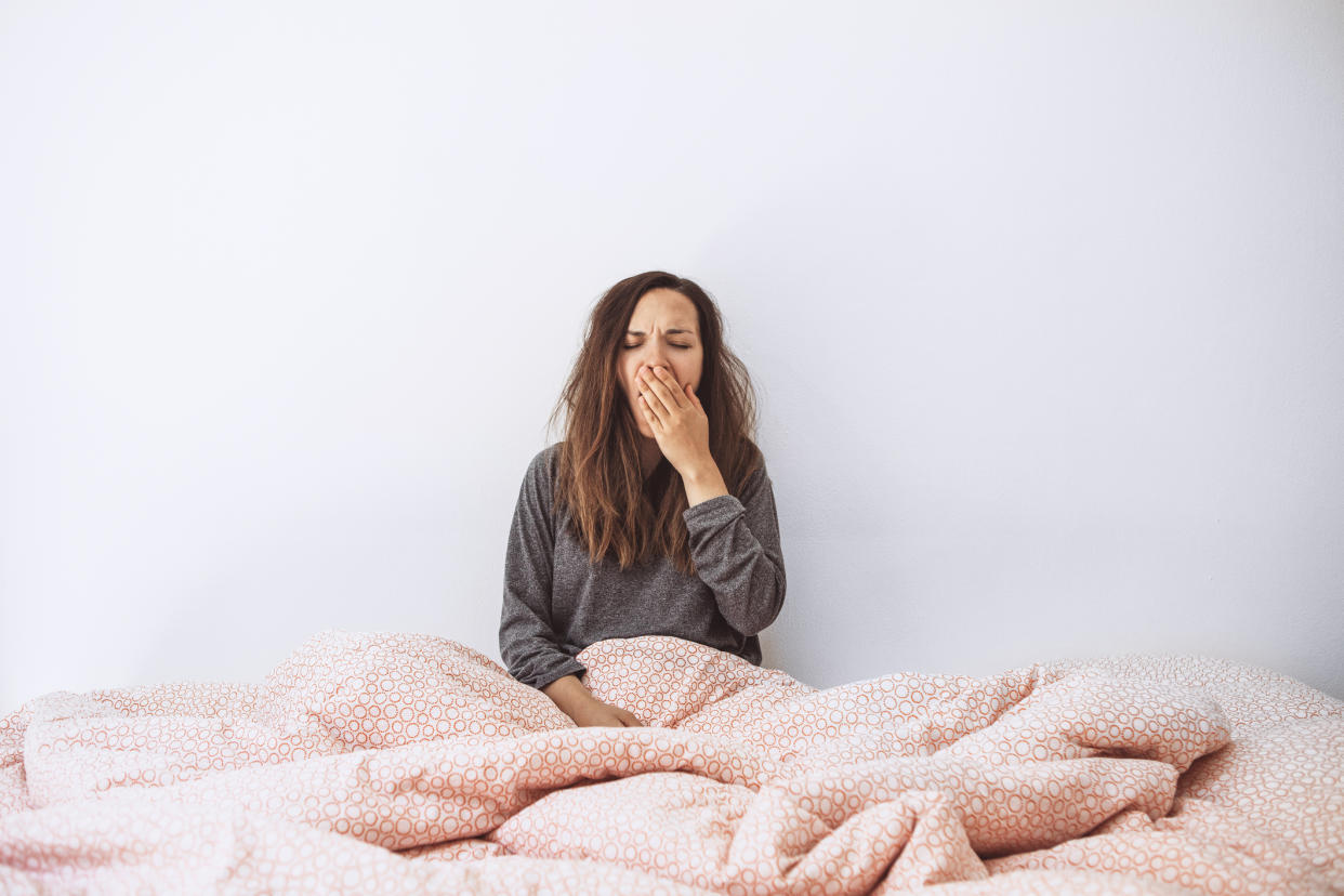 Woman feeling tired in bed. (Getty Images)
