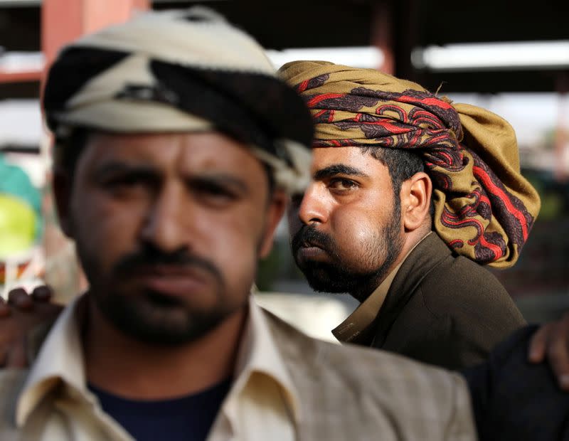 People chew qat, a mild stimulant, amid concerns of the spread of the coronavirus disease (COVID-19) at a fruit market in Sanaa