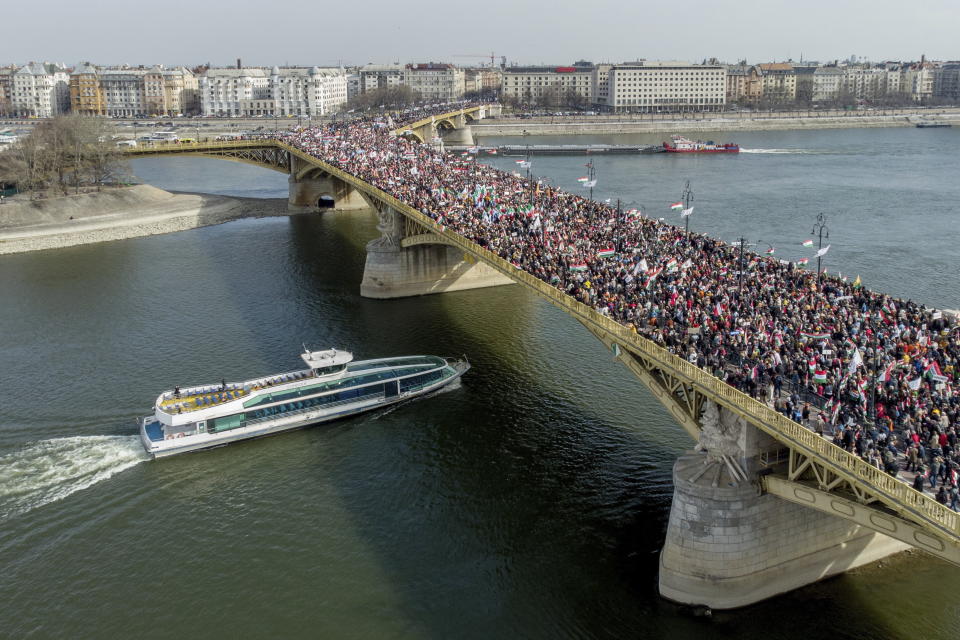 People cross Margaret Bridge as they participate in the Peace March, a demonstration organized by the pro-government Civic Solidarity Forum Foundation to express support for the current Hungarian government with regard to the upcoming general elections in April in Budapest, Hungary, Tuesday, March 2022, coinciding with the national holiday marking the 174th anniversary of the outbreak of the 1848 revolution and war of independence against the Habsburg rule. (Zsolt Czegledi/MTI via AP)