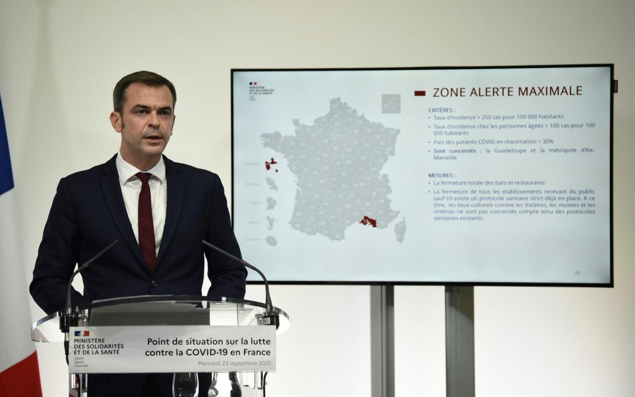 French Health Minister Olivier Veran speaks near a map of France showing the Marseille region in red during a press conference in Paris, - Eliot Blondet/ Abaca