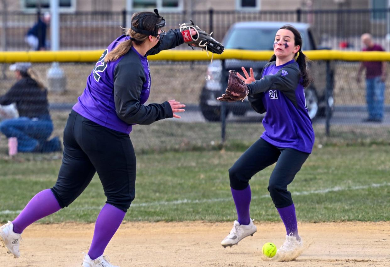 Martha's Vineyard third baseman Kylee Brasefield (22) and shortstop Bella Arters reach for a pop-up hit by Summer Washabough of Bourne.