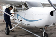 Military helicopter pilot Henery Jacobs looks over a fixed wing aircraft at Coast Flight Training in San Diego, California, U.S., January 15, 2019. Picture taken January 15, 2019. REUTERS/Mike Blake