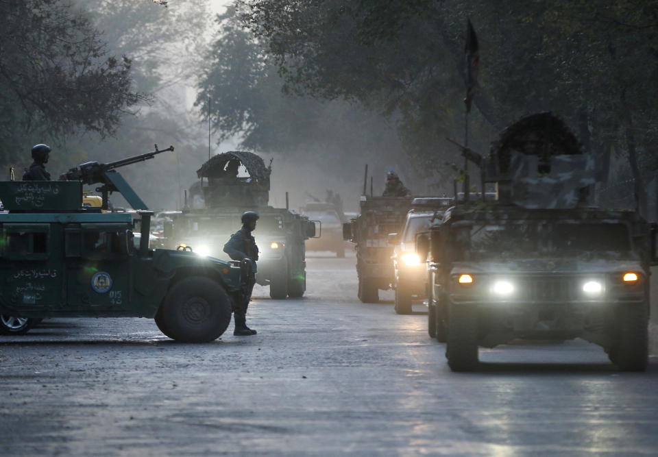 Afghan security forces leave the site of an incident after an attack at the university of Kabul.