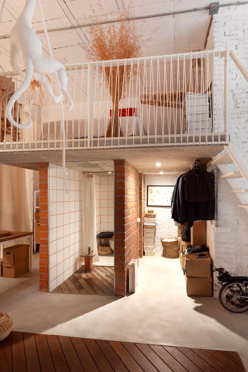 View of loft apartment spaces with red brick and painted white brick