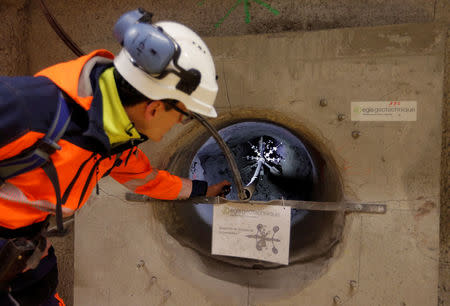 Mathieu Saint-Louis, spokesperson for the French National Radioactive Waste Management Agency ANDRA, shows a cavity designed to receive nuclear waste containers at the underground research laboratory of the Agency, located 500 meters underground, in Bure, France, April 5, 2018. Picture taken April 5, 2018. REUTERS/Vincent Kessler