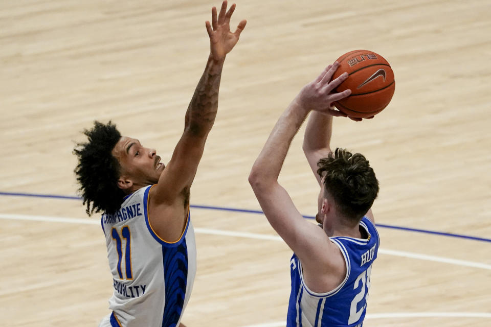 Pittsburgh's Justin Champagnie (11) defends as Duke's Matthew Hurt shoots during the second half of an NCAA college basketball game, Tuesday, Jan. 19, 2021, in Pittsburgh. Pittsburgh won 79-73. (AP Photo/Keith Srakocic)