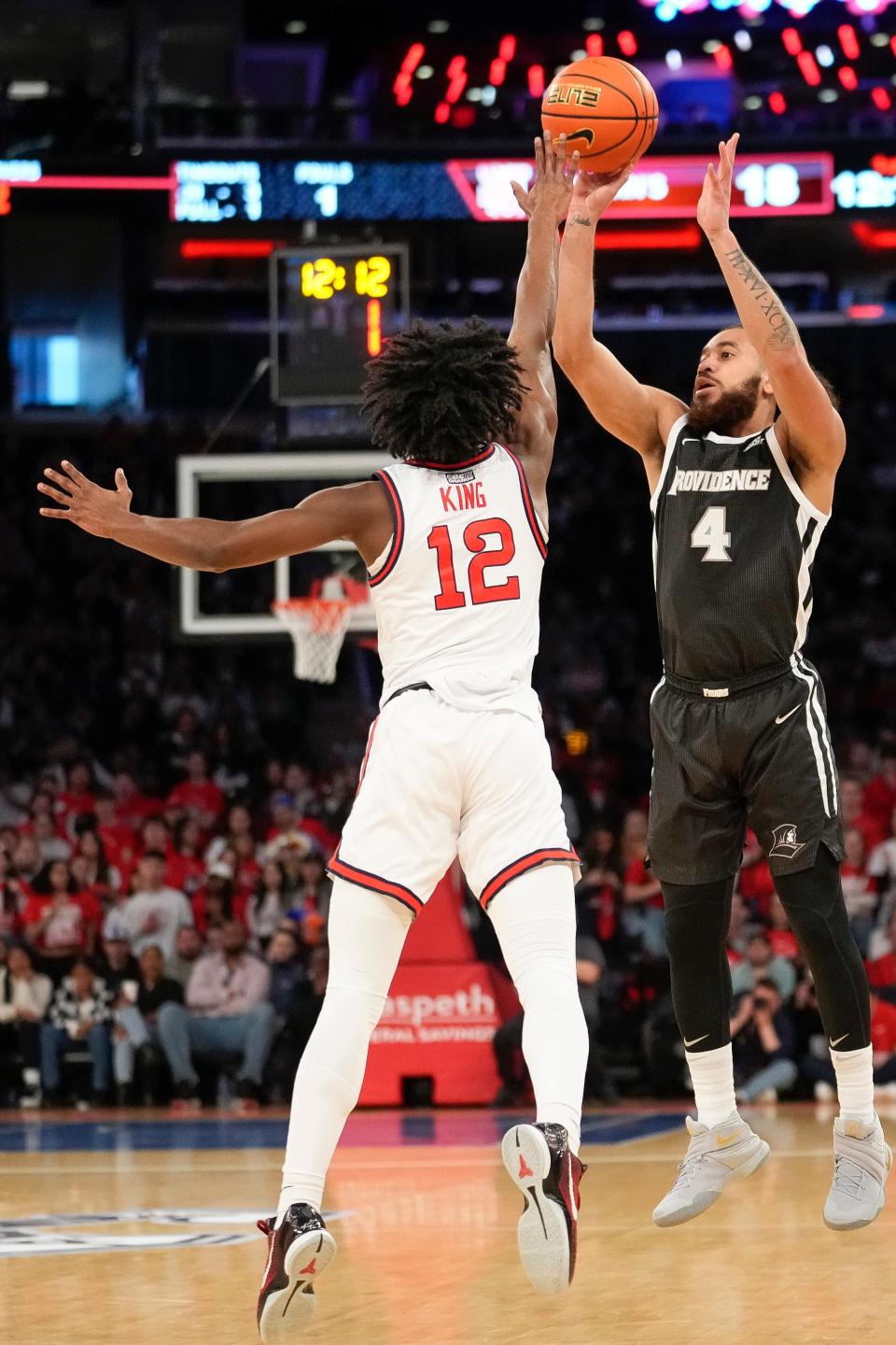 Friars guard Jared Bynum gets off a shot over Red Storm guard Kolby King during the first half on Saturday.