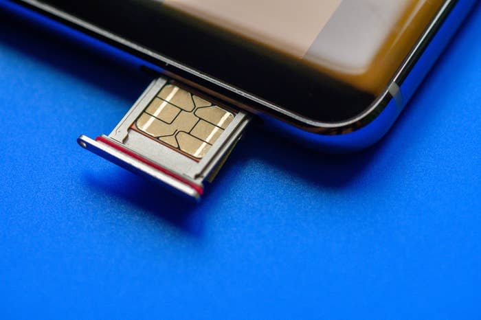 A SIM card being inserted into a phone.