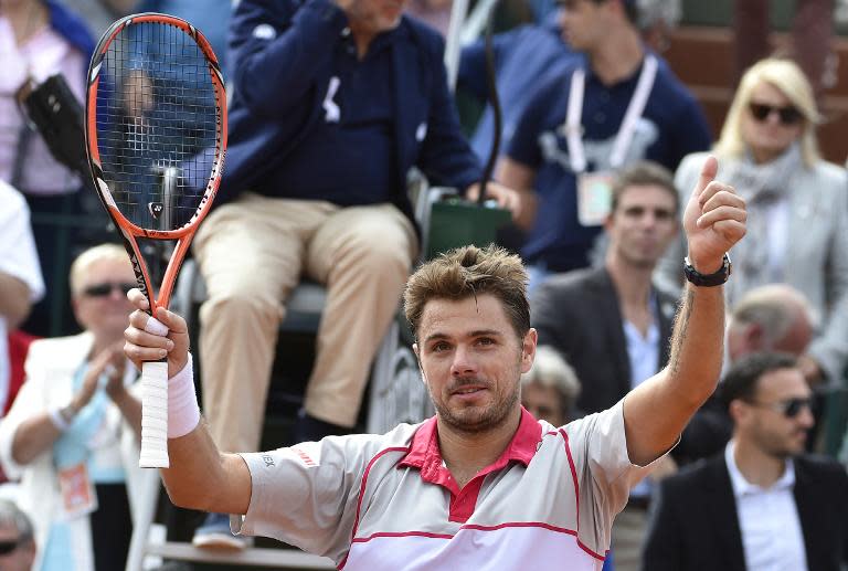 Switzerland's Stanislas Wawrinka celebrates after winning his match against US player Steve Johnson during the men's third round of the Roland Garros 2015 French Tennis Open in Paris on May 29, 2015