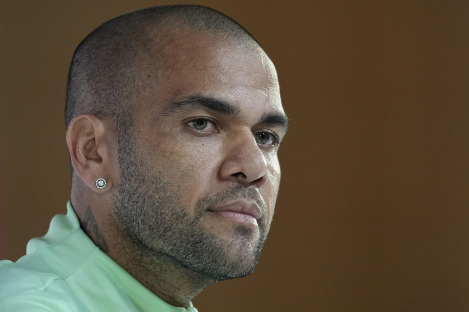 FILE - Brazil's Dani Alves listens to a question during a press conference on the eve of the group G of World Cup soccer match between Brazil and Cameroon in Doha, Qatar, on Dec. 1, 2022. A Barcelona-based court says that Brazilian soccer star Dani Alves’ sexual assault trial will start on Feb. 5. Alves is accused of allegedly sexually assaulting a young woman in a Barcelona night club last in December 2022. (AP Photo/Andre Penner, File)