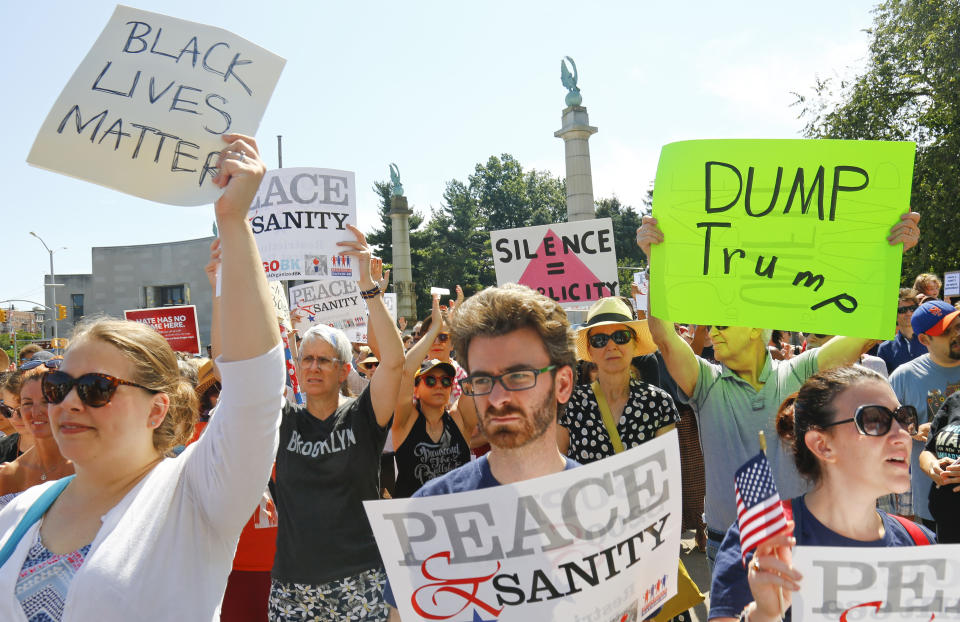 <p>Protesters listen during a “Peace and Sanity” rally Sunday Aug. 13, 2017, in New York, as speakers address white supremacy violence in Charlottesville, Va., yesterday. (AP Photo/Bebeto Matthews) </p>