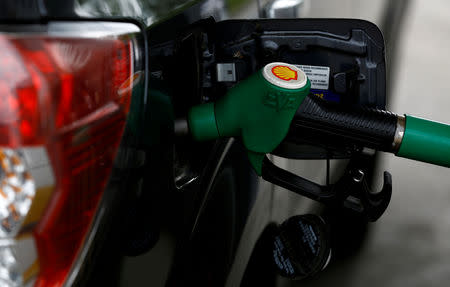 FILE PHOTO: A Shell logo is seen on fuel pump while a car is refueled at in Warsaw, Poland, June 1, 2017. REUTERS/Kacper Pempel