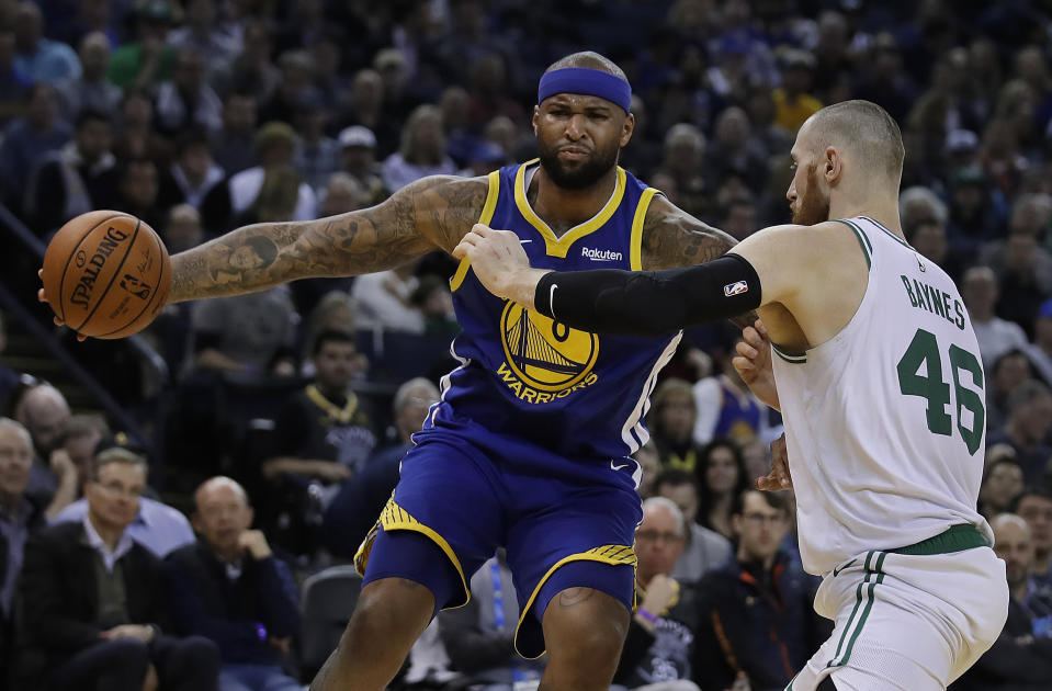 Golden State Warriors' DeMarcus Cousins, left, drives the ball against Boston Celtics' Aron Baynes (46) during the first half of an NBA basketball game Tuesday, March 5, 2019, in Oakland, Calif. (AP Photo/Ben Margot)