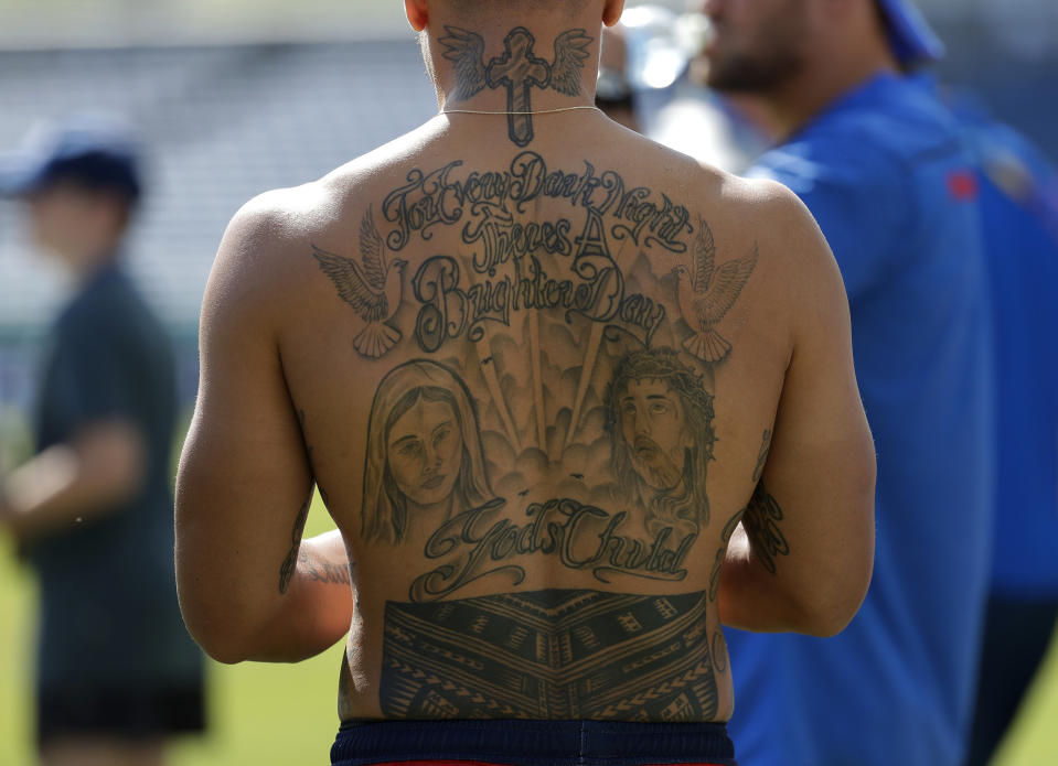 Tatoos are seen on the back of Samoa rugby player Tim Nanai-Williams as he prepares for training during the Rugby World Cup Pool A games in Fukuoka, Japan, Friday, Oct. 11, 2019. Samoa will play against Ireland Oct. 12 in Fukuoka while games against England and France in Yokohama and the match between New Zealand and Italy at Toyota city have been cancelled due to the upcoming Typhoon Hagibis. (AP Photo/Aaron Favila)