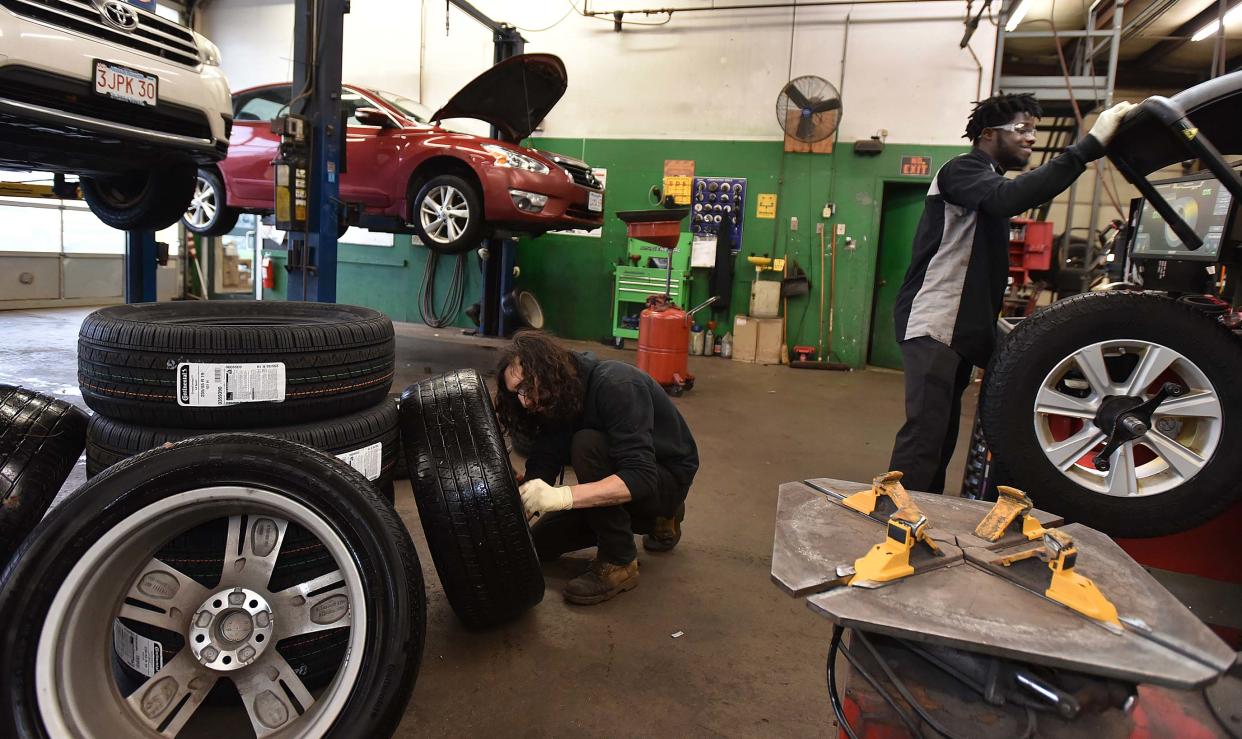 Sullivan Tire employees Dan Finnegan, left, and Paul Myers work on balancing tires at their service center on Airport Road in Hyannis. Earlier this month, the company announced an Employee Stock Ownership Plan that will turn over ownership of the 68-year-old, family-owned company to its employees.