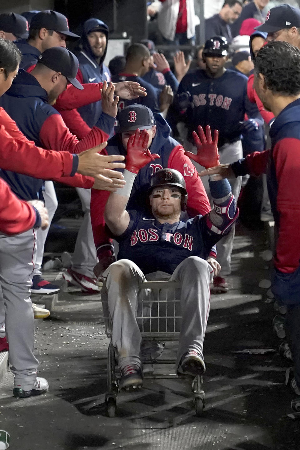 Boston Red Sox's Christian Vazquez celebrates his three-run home run in the dugout during the fifth inning of a baseball game against the Chicago White Sox Tuesday, May 24, 2022, in Chicago. (AP Photo/Charles Rex Arbogast)