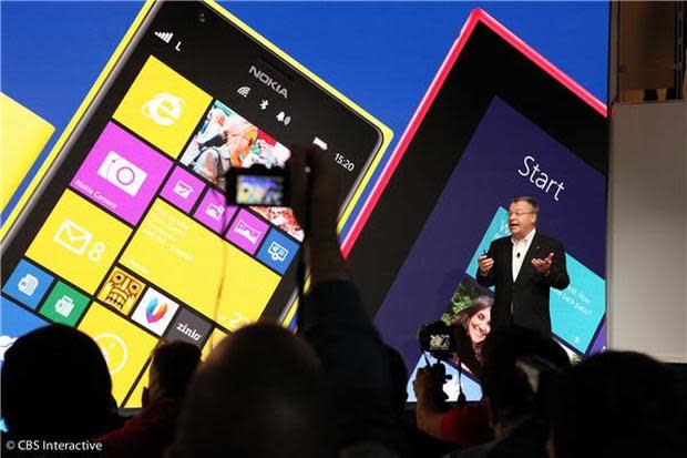Stephen Elop, who will be leaving Microsoft, talks up Windows Phone at an event last year. The company's reorg shows that Microsoft 