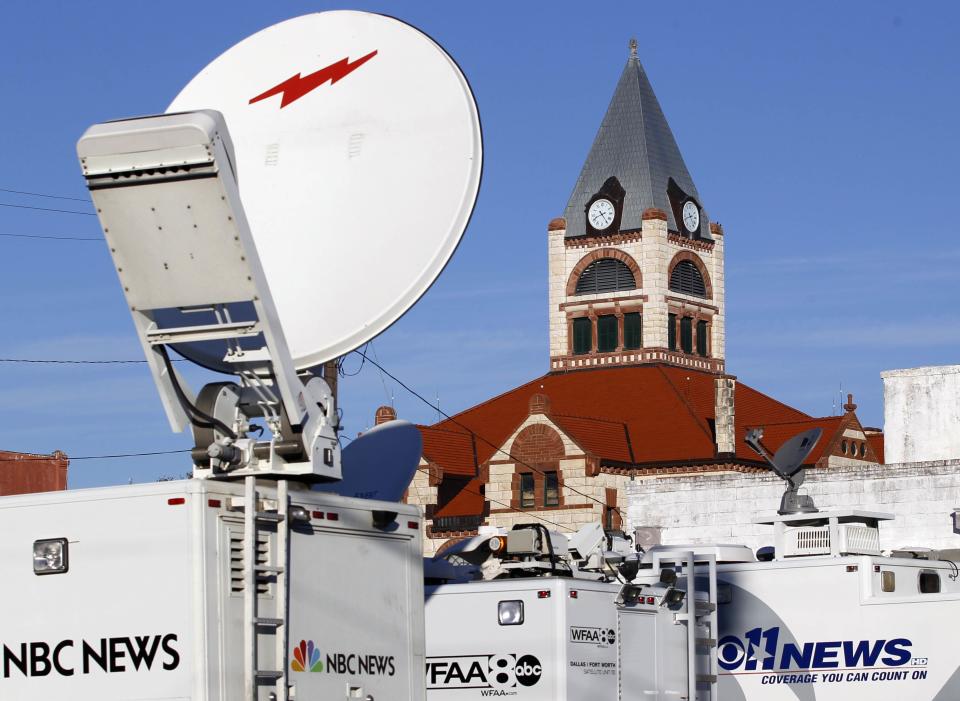 News trucks fill a parking lot near the Stephenville town square. (REUTERS/Mike Stone)