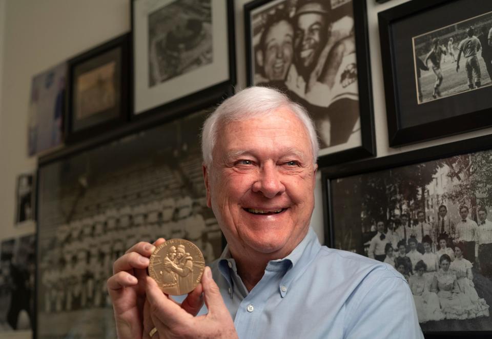 Gregory Gromek, of Beverly Hills, holds a replica Congressional Gold Medal at his home on Wednesday, March 13, 2024, that resembles the one awarded to Larry Doby. The medal includes a photo of Doby and Gromek's father, Cleveland Indians pitcher Steve Gromek, from the 1948 World Series in which Doby hit the deciding home run. In 1947, Doby had become the first Black player in the American League, only 11 weeks after Jackie Robinson integrated Major League Baseball.
The wire photo of the hug was available nationwide, but some papers refused to run it, and when Gromek came home, some of his old friends wouldn’t talk to him.