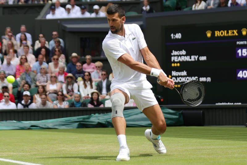 Serbian Novak Djokovic uses a backhand return against Great Britain's Jacob Fearnley at Wimbledon 2024 on Thursday in London. Photo by Hugo Philpott/UPI