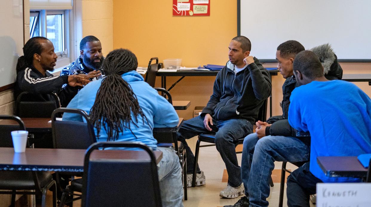 Men discuss a problem they chose to solve in the Strong Fathers class Wednesday, Nov. 1, 2023 at the Fathers & Families Center.