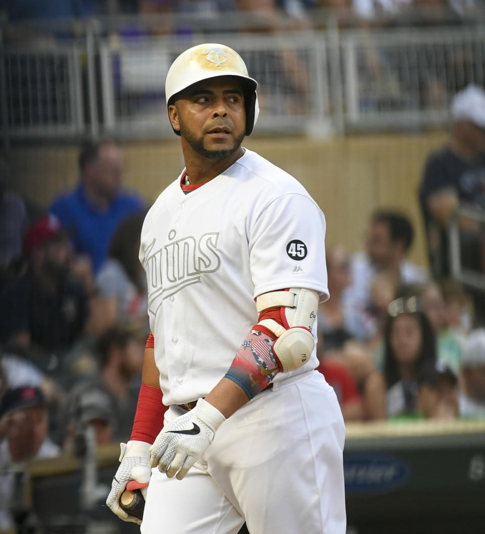 Minnesota Twins designated hitter Nelson Cruz looks back at Detroit Tigers pitcher Edwin Jackson after striking out swinging during the third inning of a baseball game Saturday, Aug. 24, 2019, in Minneapolis. (AP Photo/Craig Lassig)