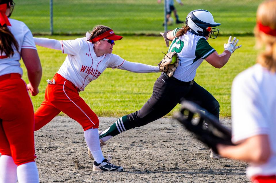 New Bedford's left fielder, Abby Perry, tags out Dartmouth's baserunner, Lily Gioiosa, who was caught in a run down.