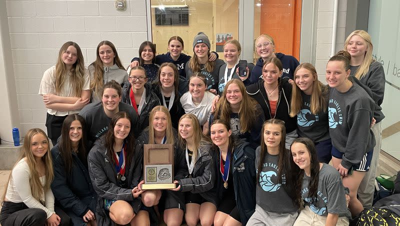 Members of the Millard High girls swim team pose for a picture after claiming the Region 2 title.