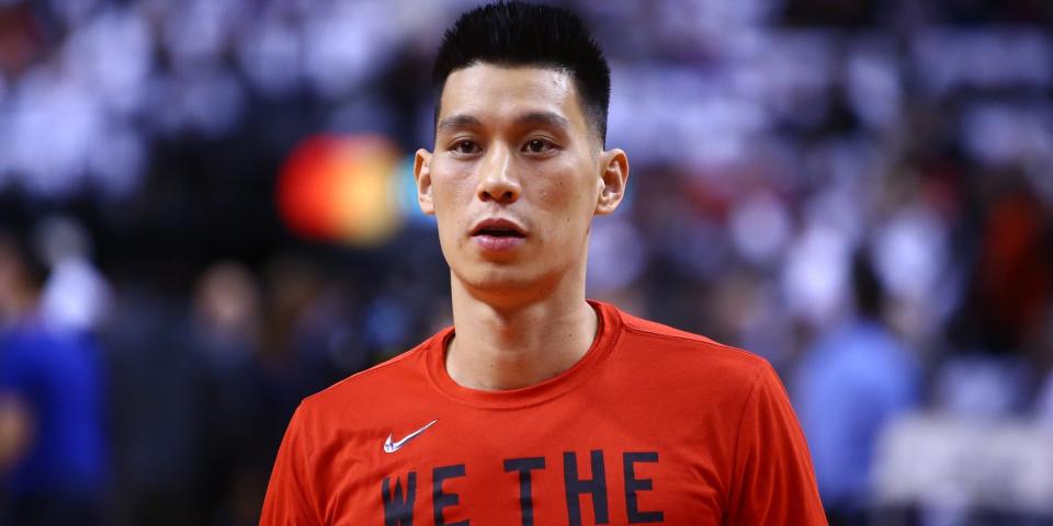 Jeremy Lin looks on while wearing warmups before a Raptors game in 2019.