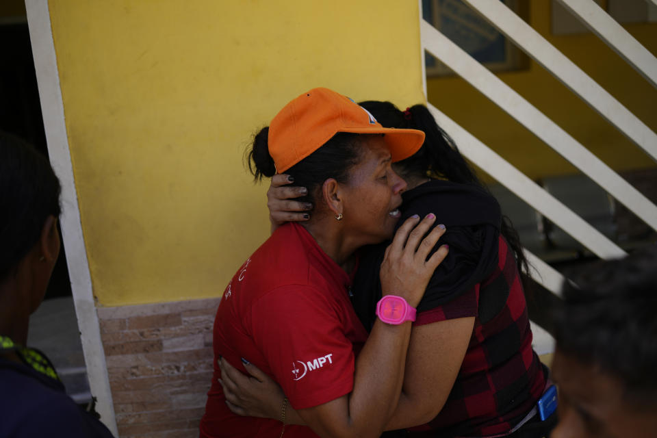 Magaly Colmenares cries as the body of her seven-year-old grandson Angel Senprum is brought to a community health center in Las Tejerias, Venezuela, Monday, Oct. 10, 2022. A fatal landslide fueled by flooding and days of torrential rain swept through this town in central Venezuela. (AP Photo/Matias Delacroix)