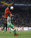 Betis' Lo Celso, right, fights for the ball with Rennes' Adrien Hunou during the Europa League round of 32 second leg soccer match between Betis and Rennes at the Benito Villamarin stadium, in Seville, Spain, Thursday, Feb. 21, 2019. (AP Photo/Miguel Morenatti)