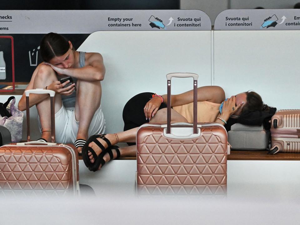 Passengers wait at Rome's Fiumicino airport during an airline workers strike that cancelled hundreds of flights on July 17, 2022.