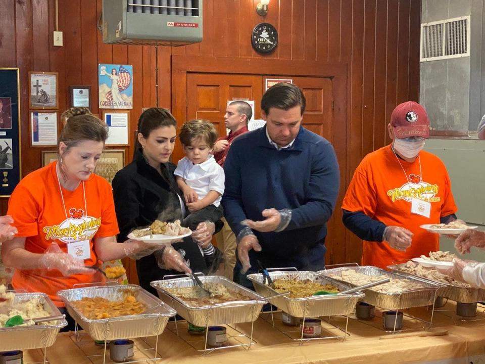 In this November 2019 photo posted on @GovRonDeSantis - the Florida governor's official Twitter page - DeSantis and first lady Casey DeSantis help serve meals during a Thanksgiving dinner hosted by an American Legion post in Tallahassee.