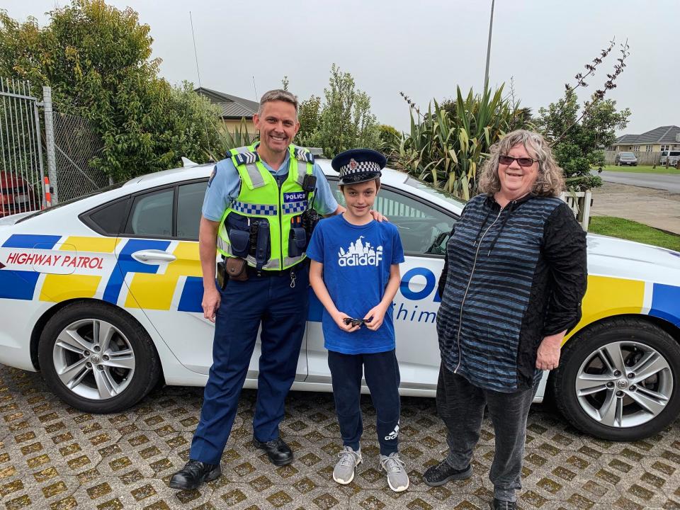 Ryan and his grandmother Kathie with Senior Sergeant Graeme Fleming at Pokeno station.