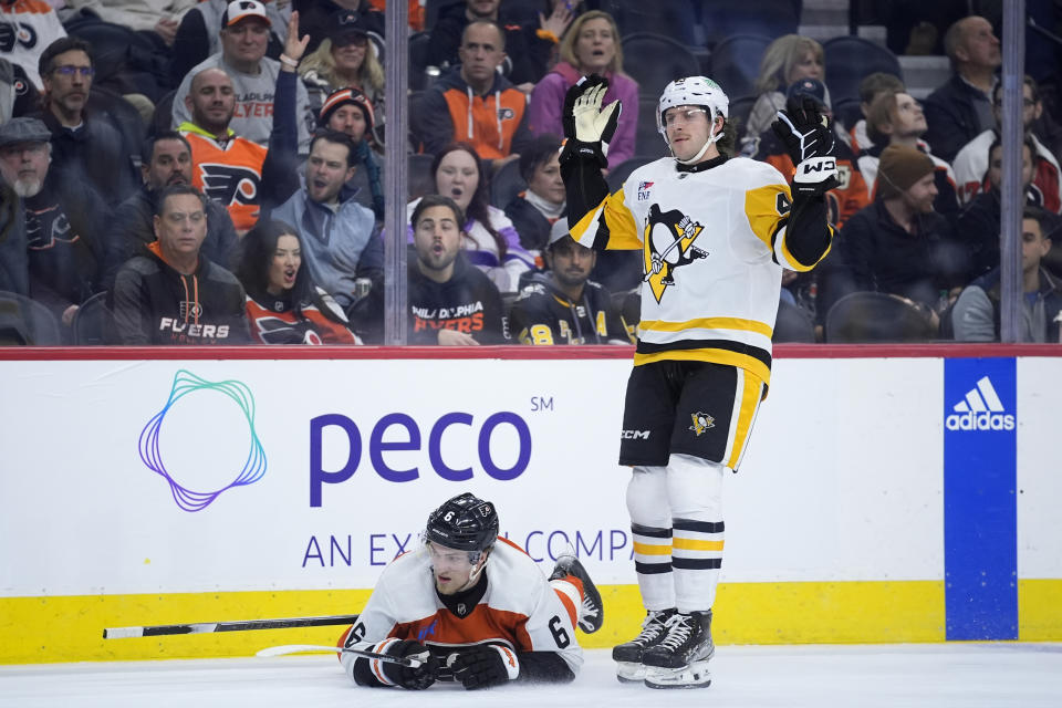 Pittsburgh Penguins' Jansen Harkins, right, reacts after a penalty is called against him after tripping Philadelphia Flyers' Travis Sanheim during the first period of an NHL hockey game, Monday, Jan. 8, 2024, in Philadelphia. (AP Photo/Matt Slocum)