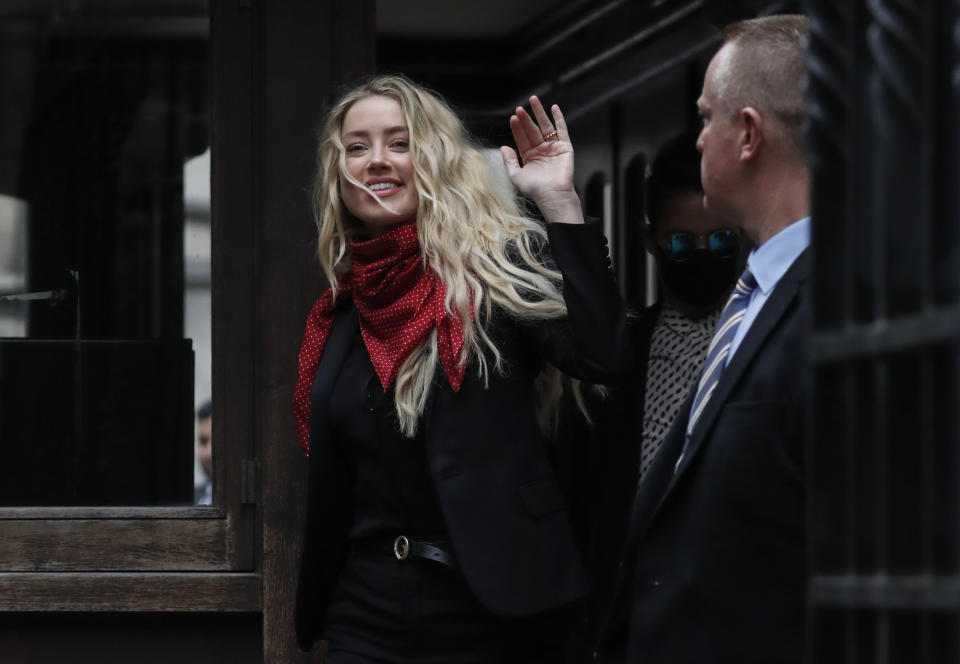 Actress Amber Heard, center, arrives at the High Court in London, Thursday, July 16, 2020. Actor Johnny Depp is suing News Group Newspapers, publisher of The Sun, and the paper’s executive editor, Dan Wootton, over an April 2018 article that called him a “wife-beater.” The Sun’s defense relies on a total of 14 allegations by Heard of Depp’s violence. He strongly denies all of them. (AP Photo/Alastair Grant)