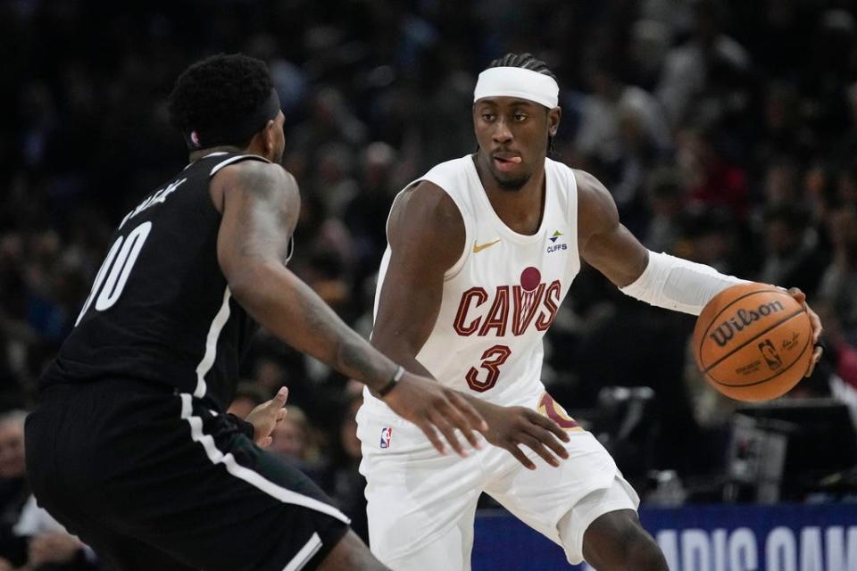 Cleveland Cavaliers' Caris LeVert, right, drives against Brooklyn Nets' Ben Simmons during the NBA basketball game between Brooklyn Nets and Cleveland Cavaliers, at the Accor Arena in Paris, Thursday, Jan. 11, 2024. (AP Photo/Christophe Ena)