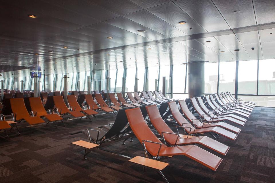 This undated handout image released by the New Hamad International Airport (HIA) which opened on Wednesday, April 30, 2014, shows a waiting lounge at one of the gates. A massive new airport in the Qatari capital has started handling its first commercial flights after years of delays as the natural-gas rich Gulf nation works to transform itself into a major aviation hub. (AP Photo/HIA)