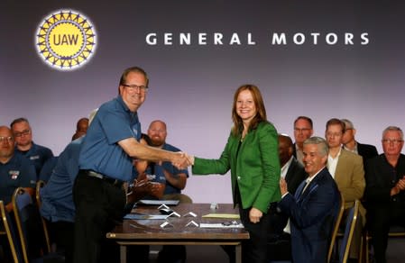 General Motors Chairman and CEO Mary Barra shakes hands with United Auto Workers President Gary Jones at the start of contract talks between the union and automaker in Detroit,