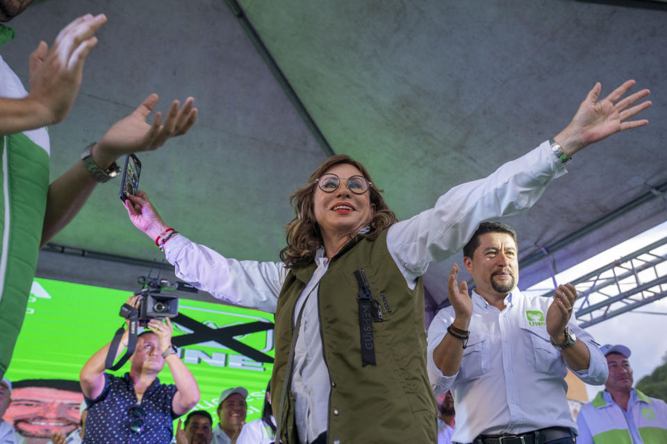 Sandra Torres, center, presidential candidate of the National Unity of Hope party, UNE, waves to supporters during a campaign rally in Santa Catarina Pinula, Guatemala, Saturday, June 17, 2023. Guatemalans go to the polls on June 25. (AP Photo/Moises Castillo)