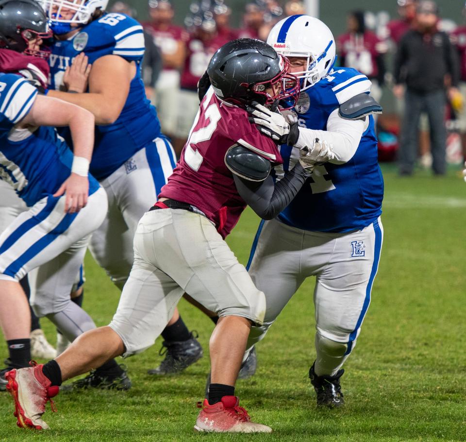 BOSTON - Leominster’s Jacob Paskell blocks Fitchburg’s Carlos Perez at Fenway Park Wednesday, November 22, 2023.