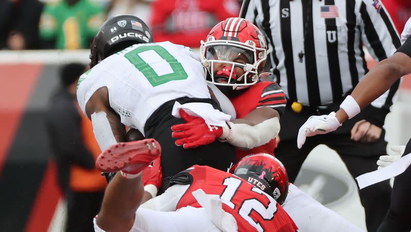 Utah defenders tackle Oregon running back Bucky Irving (0) in Salt Lake City on Saturday, Oct. 28, 2023. Oregon won 35-6.