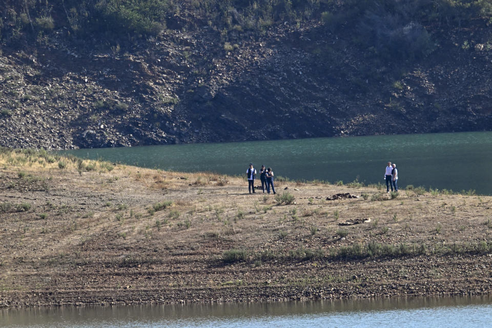 SILVES, PORTUGAL - MAY 24: German and Portuguese Judiciary police members observe the search area by the waterline for remains of Madeleine McCann at Arade reservoir at Barragem do Arade Reservoir on May 24, 2023 in Silves, Portugal. British girl, Madeleine McCann, aged 3, went missing from her bed in a holiday apartment in Praia Da Luz on the Portuguese Algarve in May 2007. German Prosecutors believe that a German national convicted of child sex offences was responsible for her abduction and possible death. The suspect is known to have visited the Portuguese reservoir several times in 2007. (Photo by Horacio Villalobos/Getty Images)